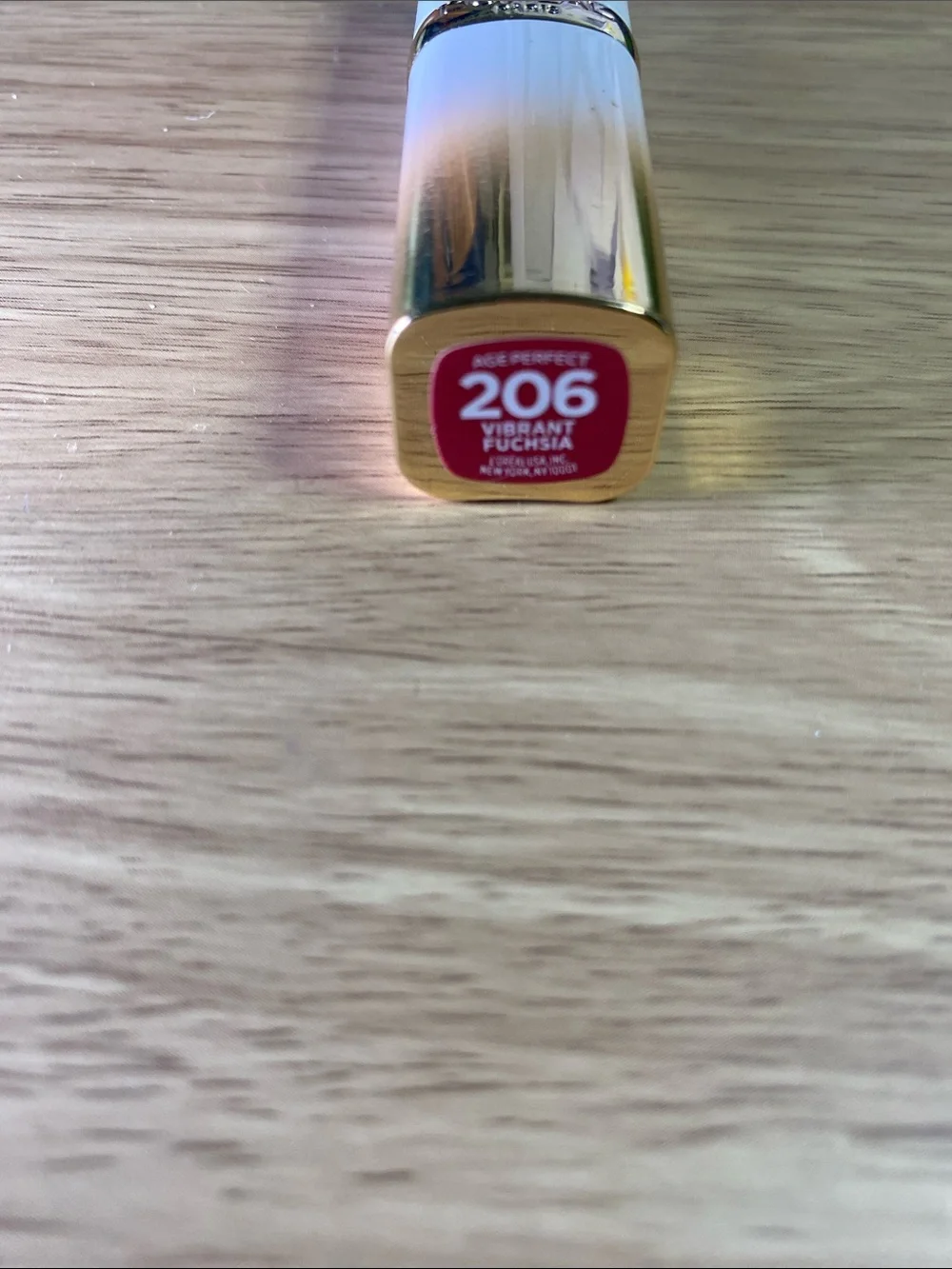 L'Oreal Gold Lipstick Tube with Vibrant Fuchsia Label 206